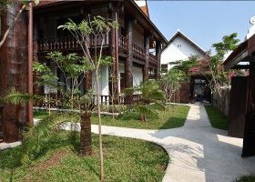 3 buildings in a little tropical garden
